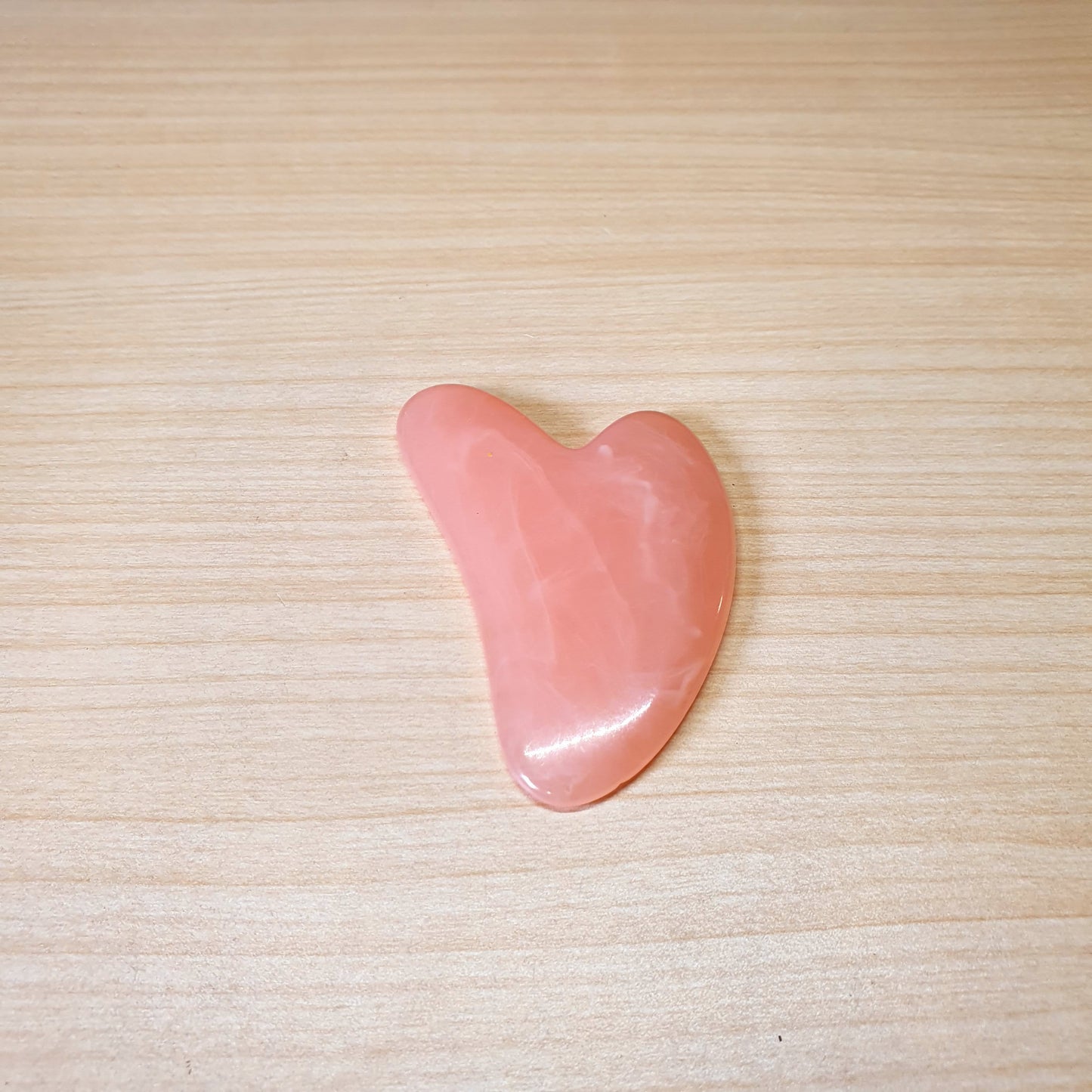 Pink, heart-shaped tool is a Gua Sha scraper, For Facial #3474