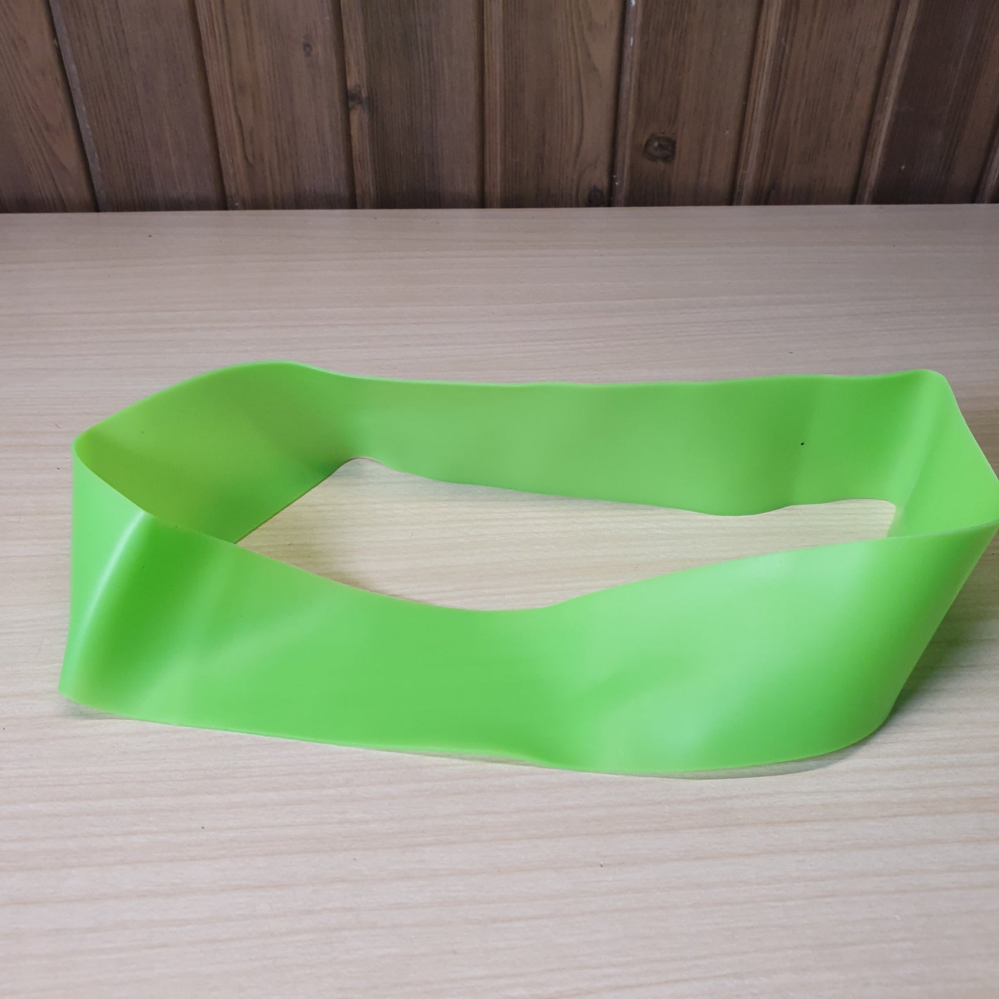Green resistance band is a versatile tool for workouts, strength training, and stretching.#6219