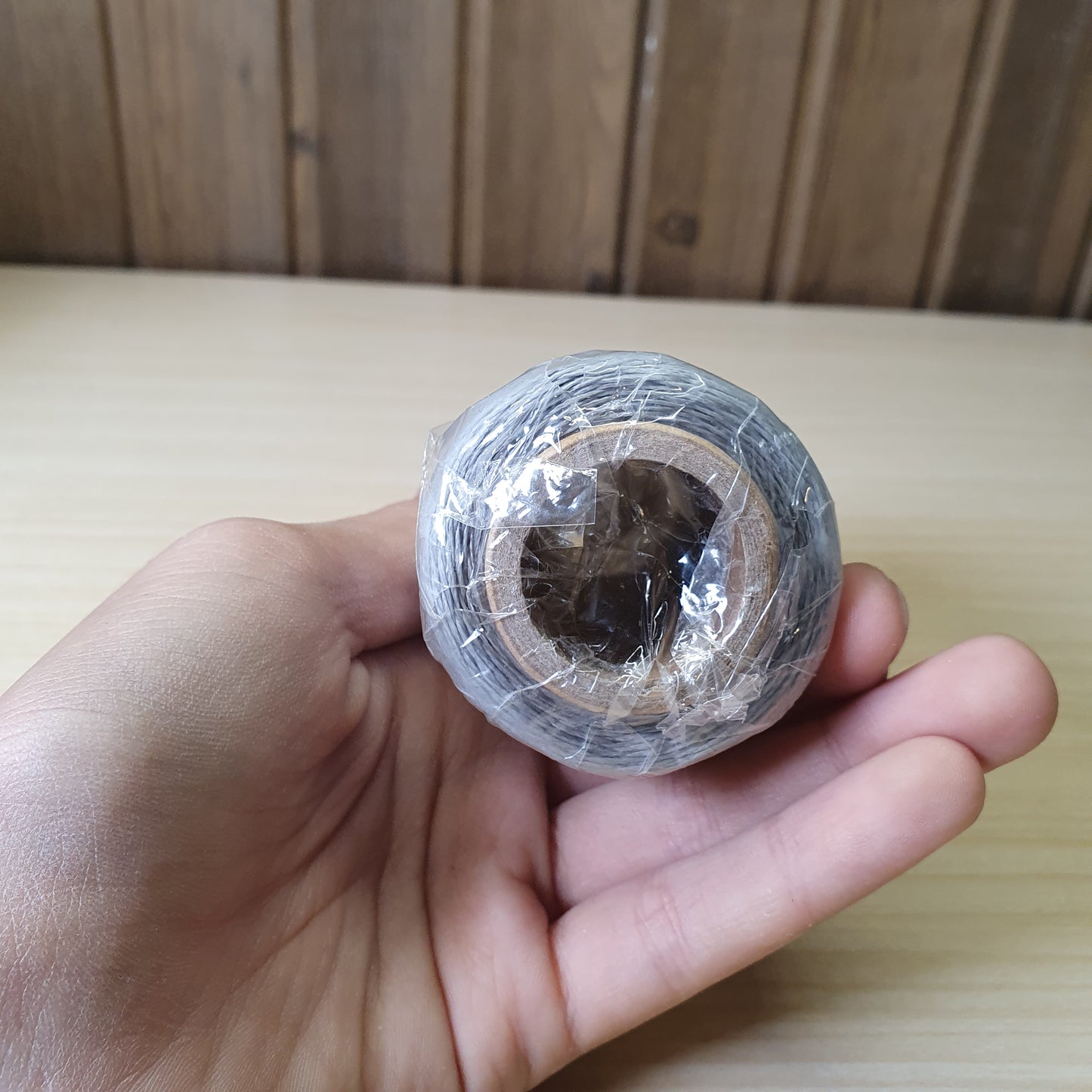 Spool of heavy-duty polyester or bonded nylon sewing thread, often used for leather crafting, upholstery, or canvas #6583