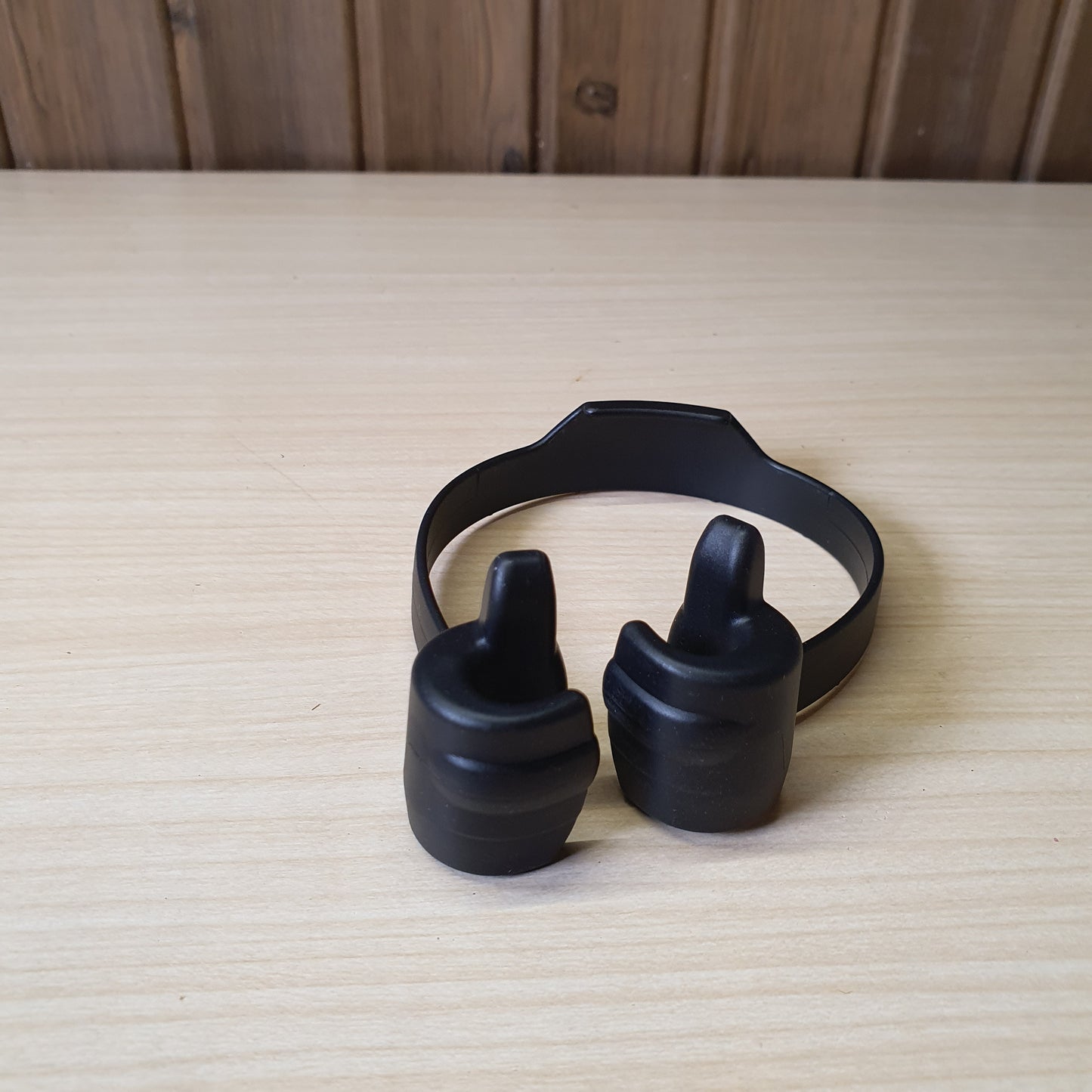 Black "OK Stand" is a flexible, TPU plastic phone holder designed with a thumbs-up shape for hands-free viewing in portrait or landscape modes. #6879
