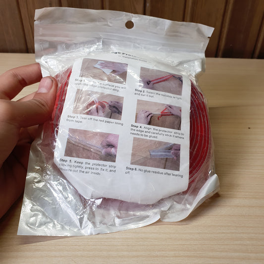 Flexible, Red-colored furniture edge protector strip designed to prevent injuries from sharp corners #8426