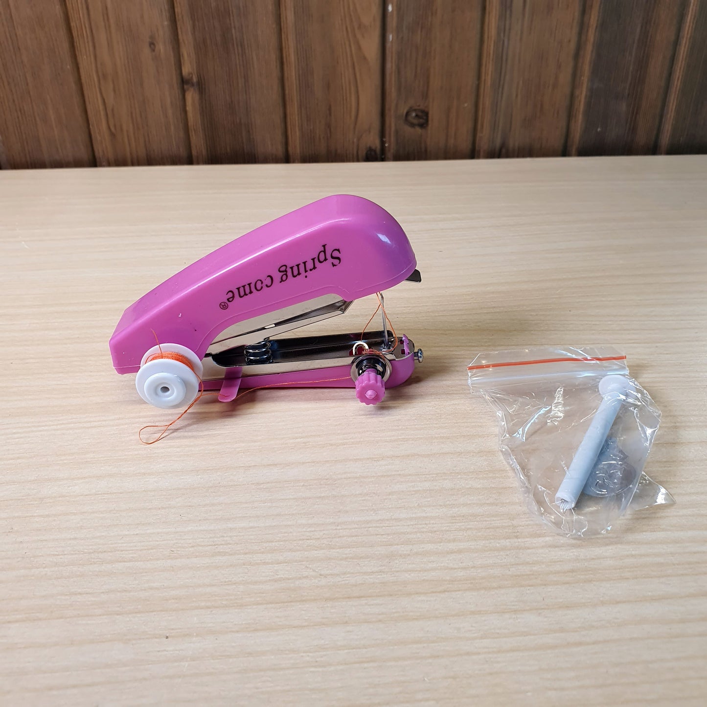 Spring Come brand handheld, portable sewing machine designed for quick repairs and DIY projects. #9289