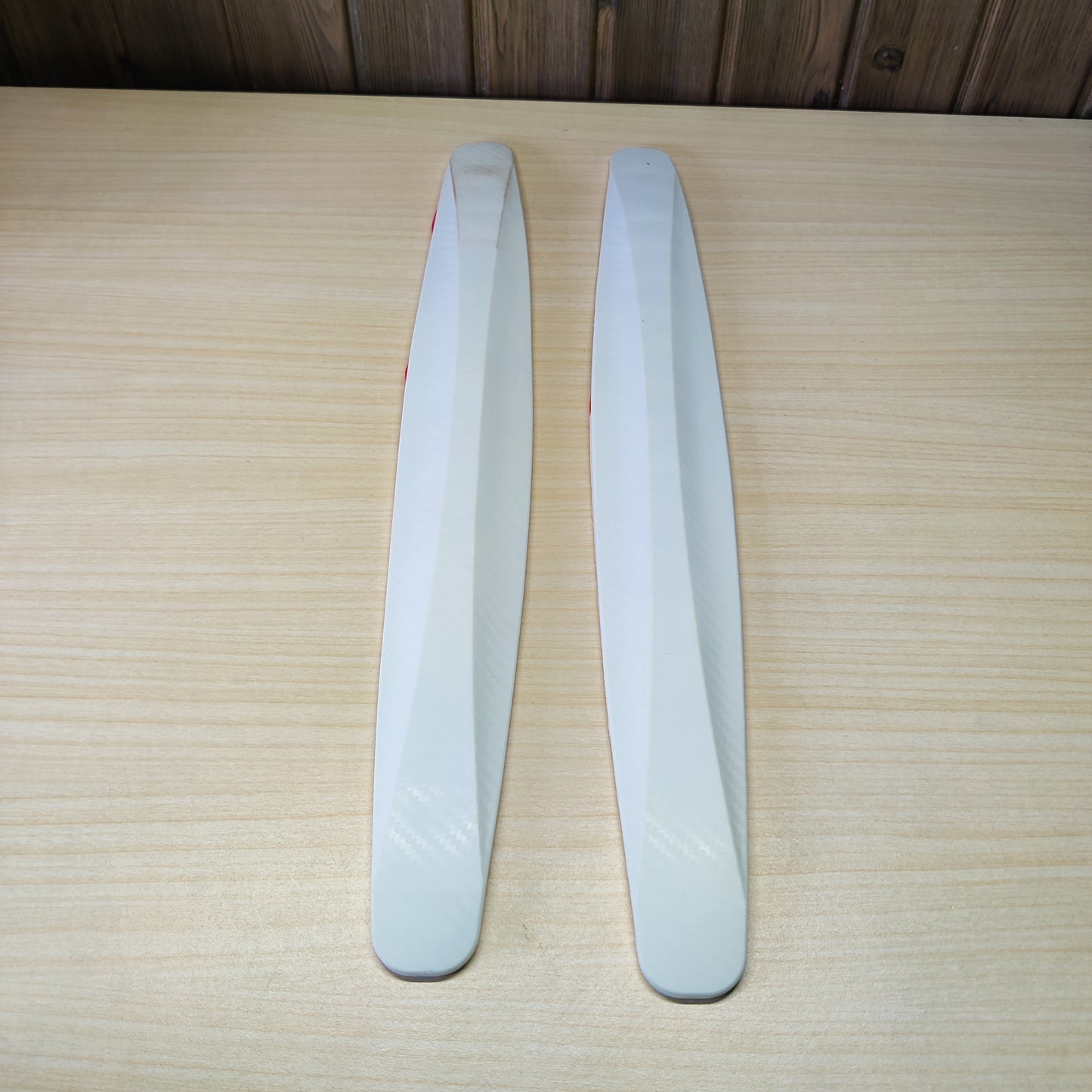 White, rubber car bumper or door edge protection strips designed to prevent scratches and minor collisions.# 2529