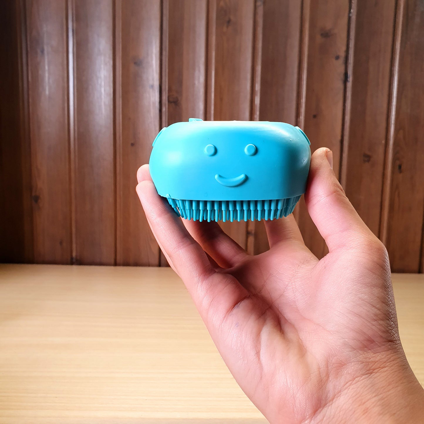 Blue silicone bath body brush featuring a built-in soap dispenser for convenient showering. #3353