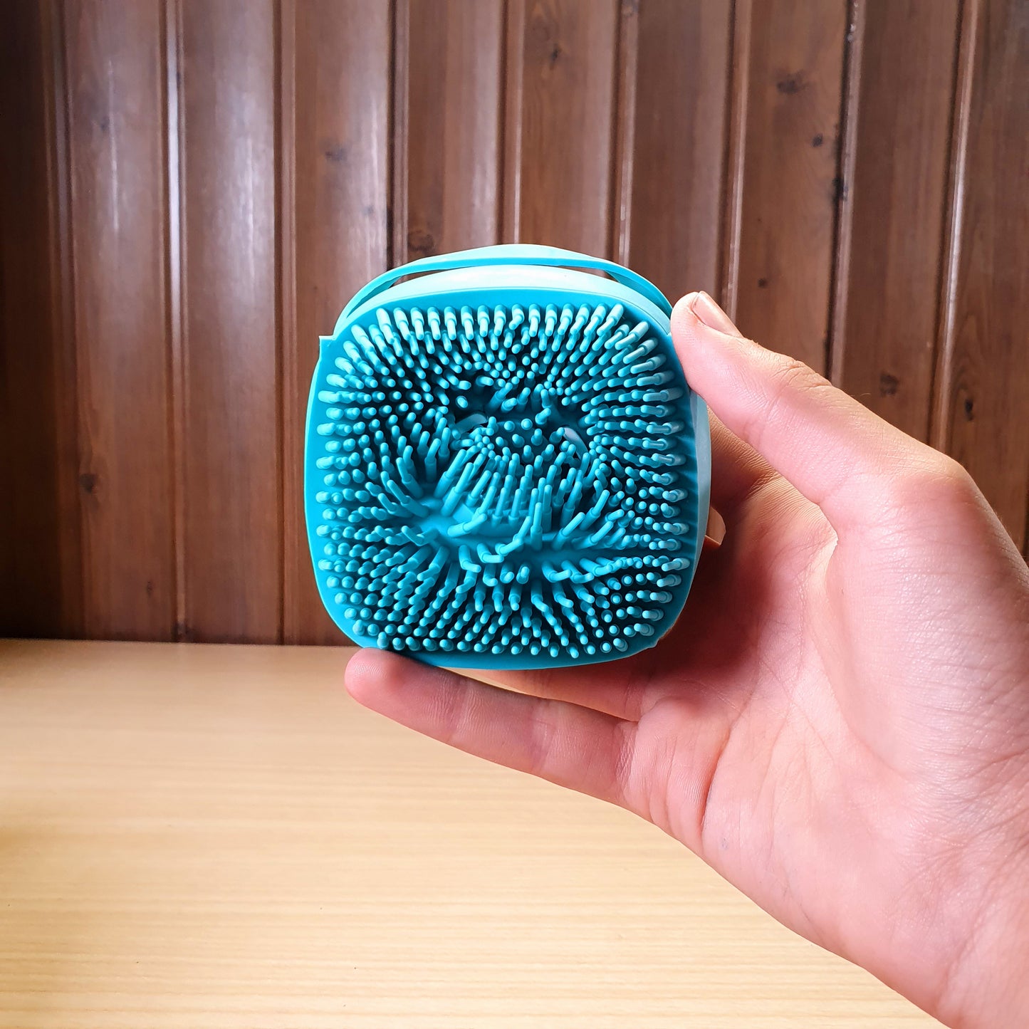 Blue silicone bath body brush featuring a built-in soap dispenser for convenient showering. #3353