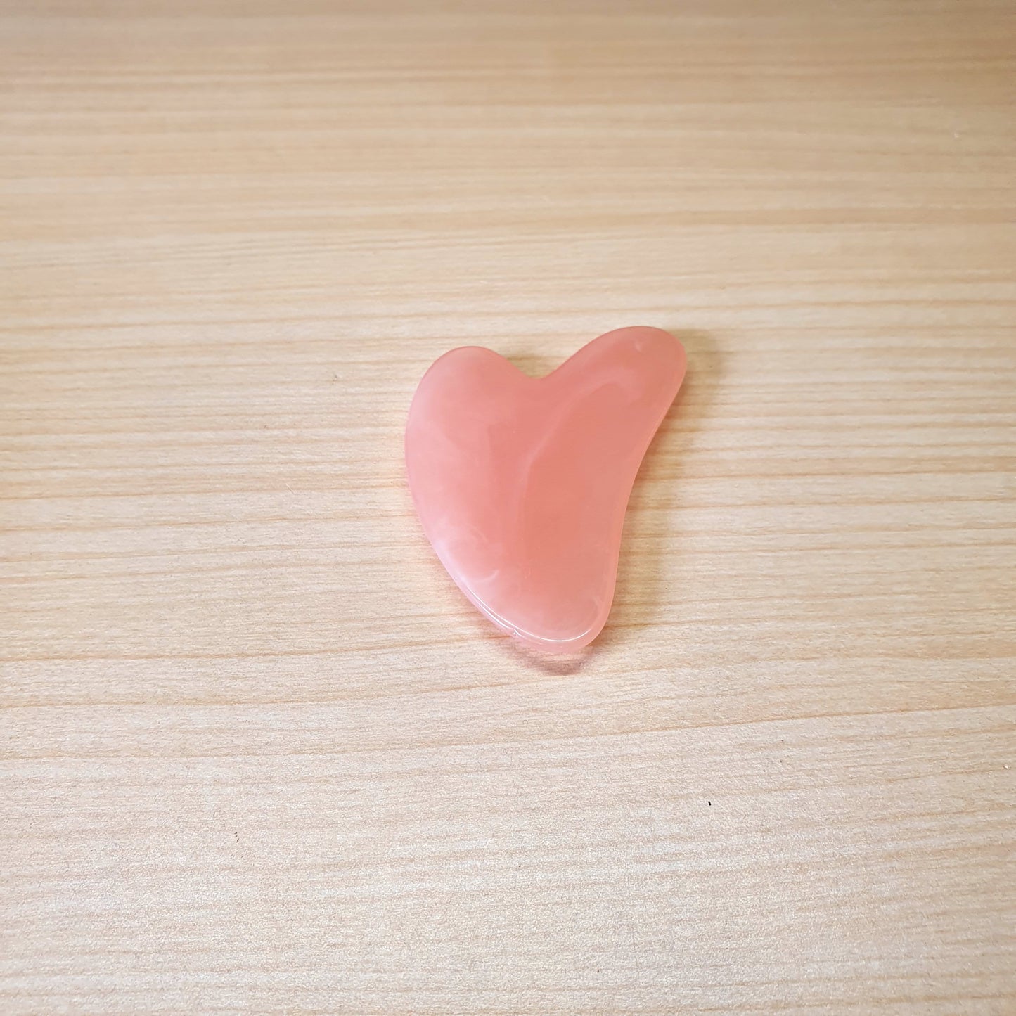 Pink, heart-shaped tool is a Gua Sha scraper, For Facial #3474