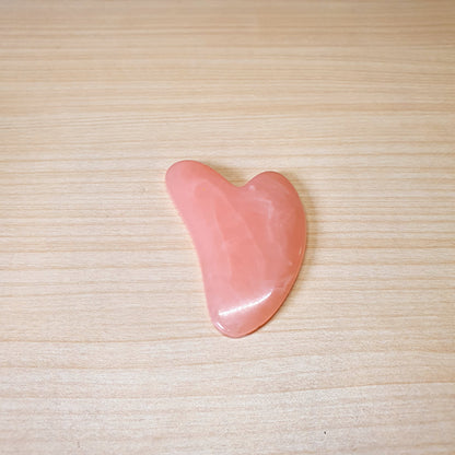 Pink, heart-shaped tool is a Gua Sha scraper, For Facial #3474