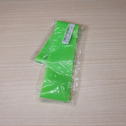 Green resistance band is a versatile tool for workouts, strength training, and stretching.#6219