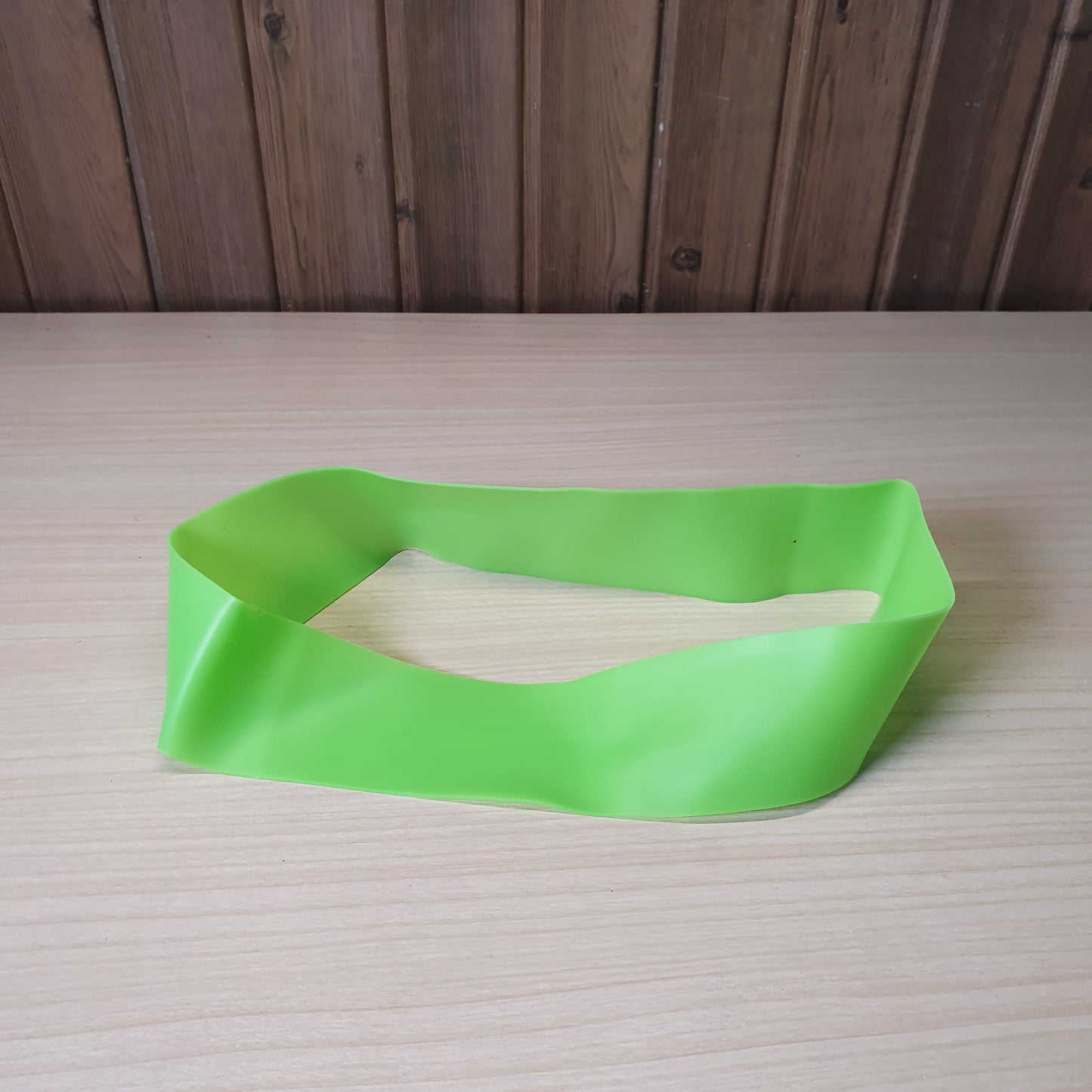 Green resistance band is a versatile tool for workouts, strength training, and stretching.#6219