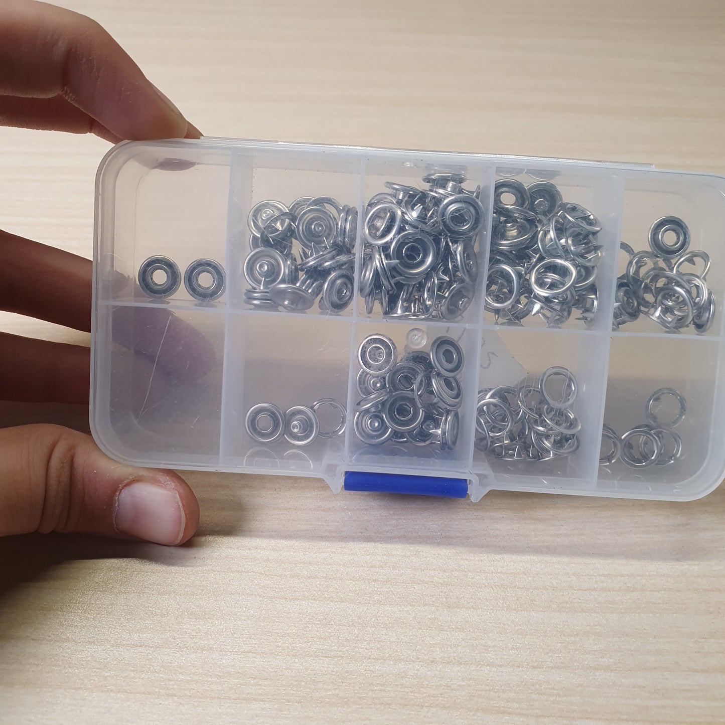 Metal snaps and fastener components, often used for sewing clothing or crafting.#6182