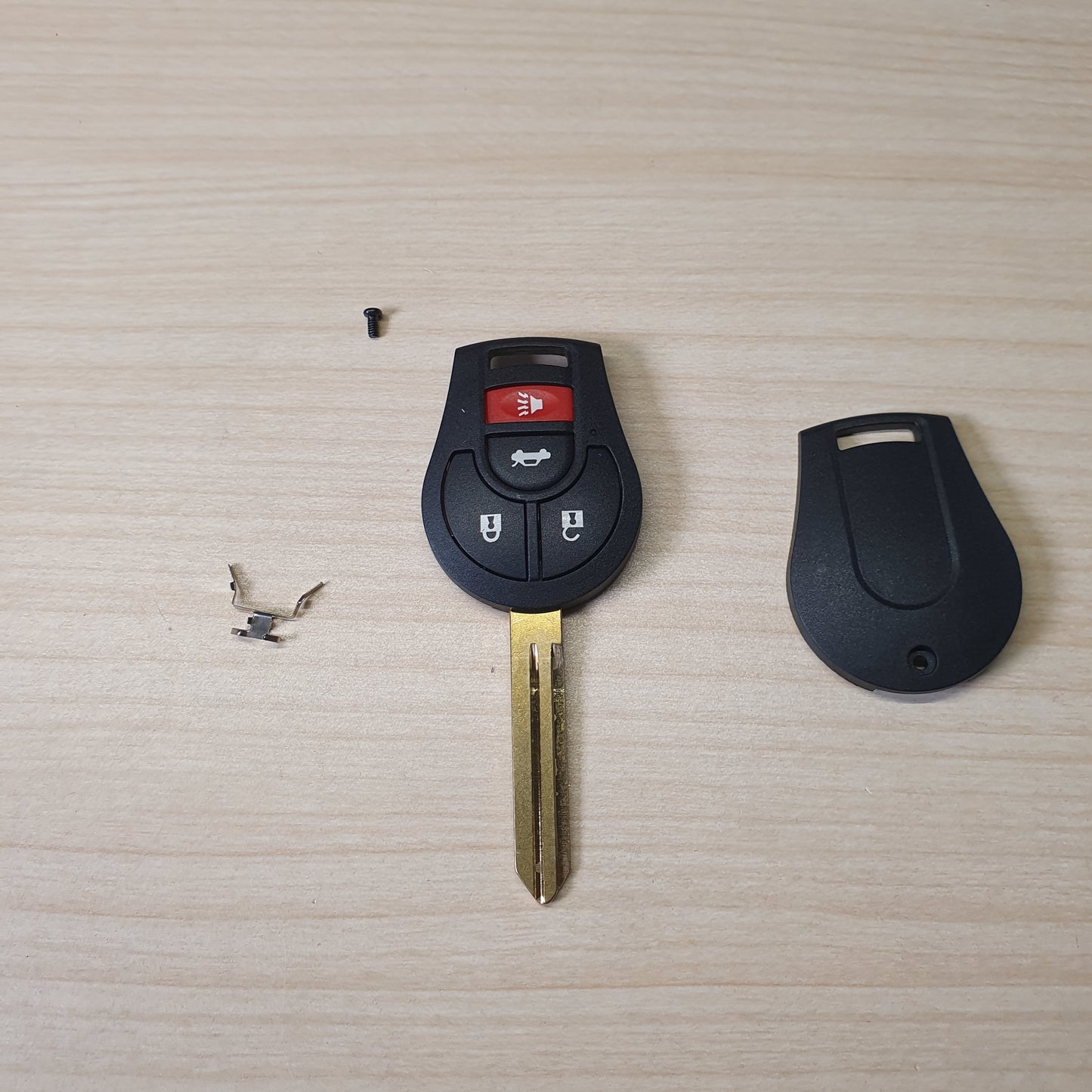 Nissan remote head key featuring a 3-button configuration (Lock, Unlock, Trunk) and an uncut brass blade # 6360