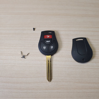 Nissan remote head key featuring a 3-button configuration (Lock, Unlock, Trunk) and an uncut brass blade # 6360