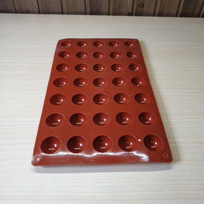 24-cavity silicone half-sphere mold typically used for making chocolates, cocoa bombs, or small mousse cakes. #6607