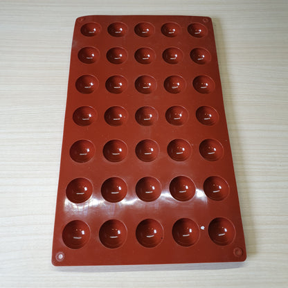 24-cavity silicone half-sphere mold typically used for making chocolates, cocoa bombs, or small mousse cakes. #6607