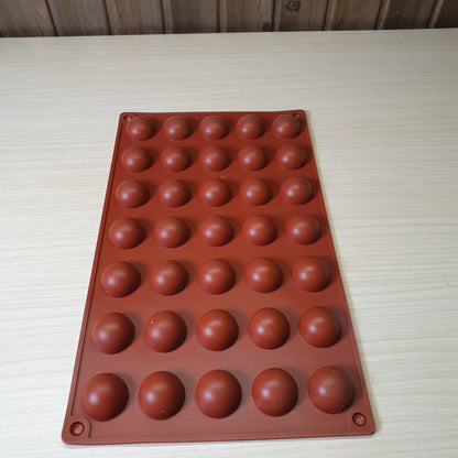 24-cavity silicone half-sphere mold typically used for making chocolates, cocoa bombs, or small mousse cakes. #6607