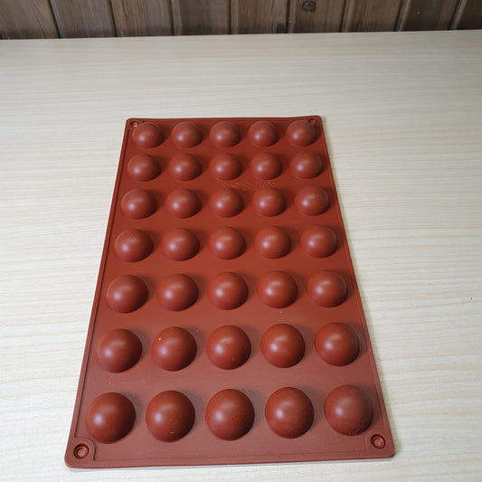 24-cavity silicone half-sphere mold typically used for making chocolates, cocoa bombs, or small mousse cakes. #6607