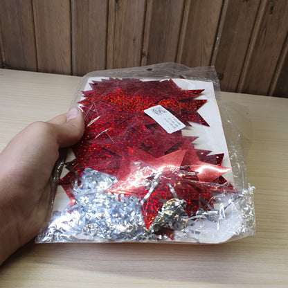 Red, star-shaped tinsel garland likely used for Christmas or party decorations.#6625