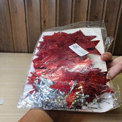 Red, star-shaped tinsel garland likely used for Christmas or party decorations.#6625