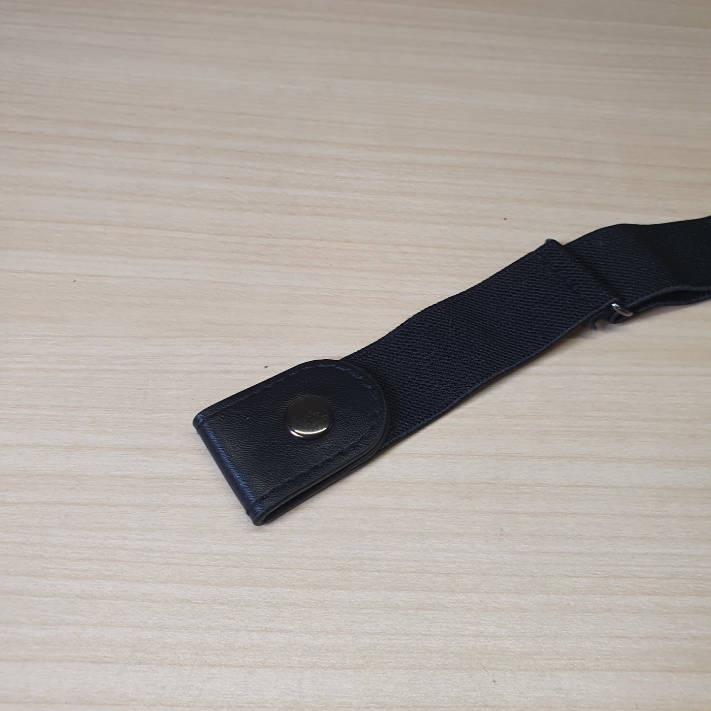 Black buckle-free elastic belt features a sleek, invisible design meant to lay flat under clothing.#6627