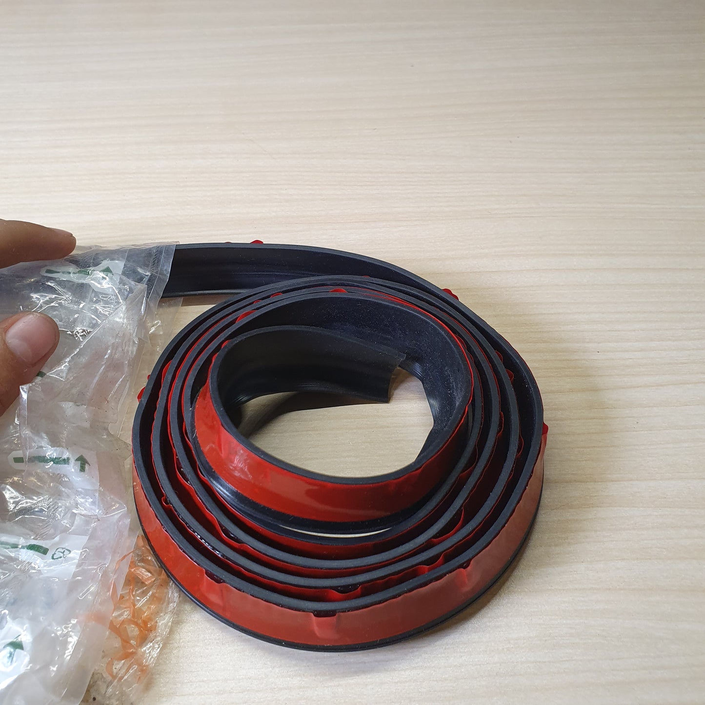 Flexible rubber strip used for various vehicle protection or sealing applications.  #6725