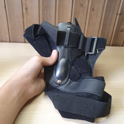 Black ankle brace with plastic side stabilizers for structural support.#6987