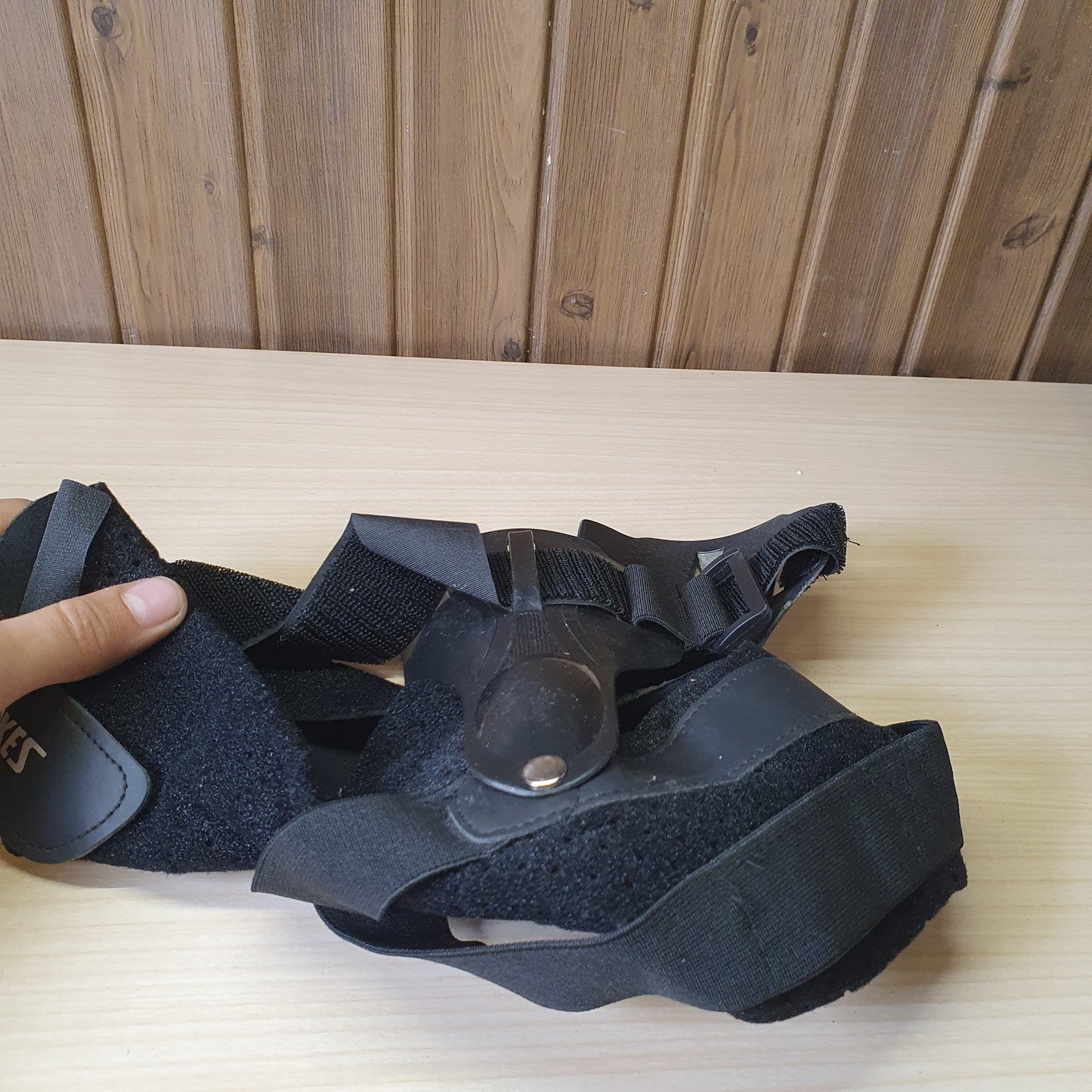 Black ankle brace with plastic side stabilizers for structural support.#6987