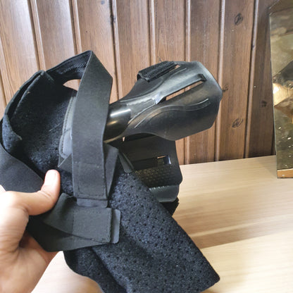 Black ankle brace with plastic side stabilizers for structural support.#6987
