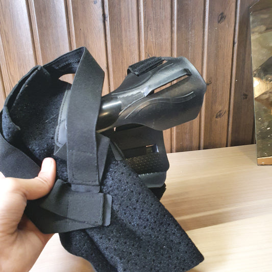 Black ankle brace with plastic side stabilizers for structural support.#6987