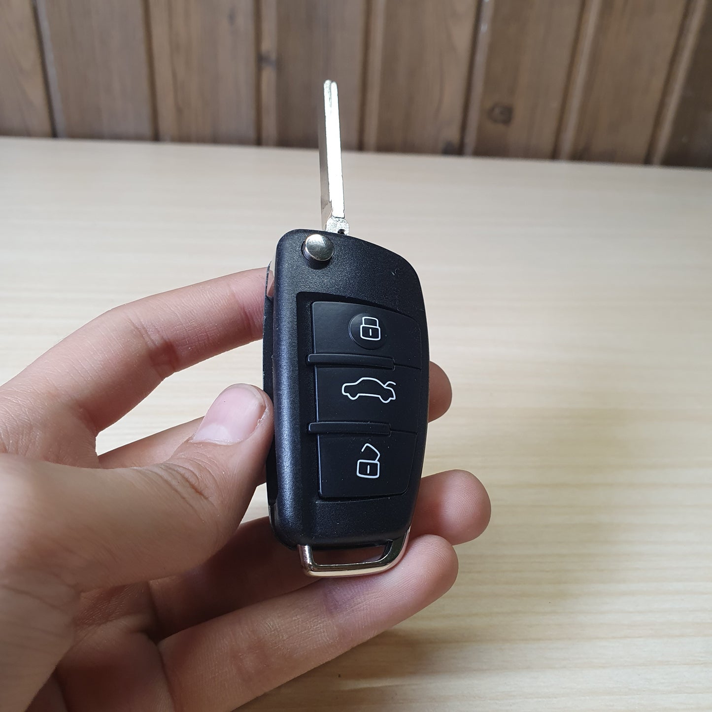 Audi flip key fob featuring a three-button layout for locking, unlocking, and trunk release. #6908
