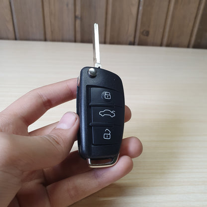 Audi flip key fob featuring a three-button layout for locking, unlocking, and trunk release. #6908