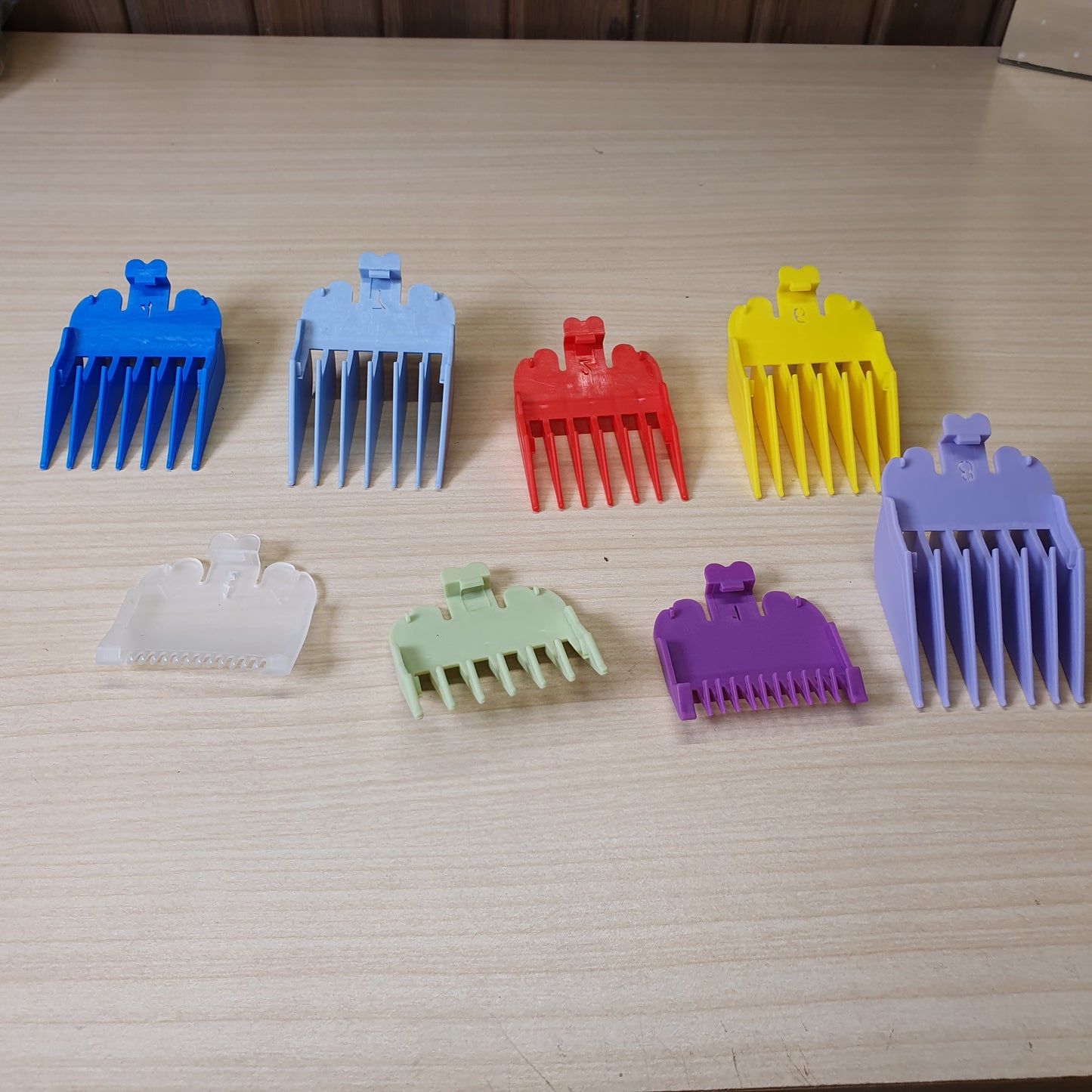 Colorful plastic limit combs designed to fit on professional hair clippers and trimmers.#6932