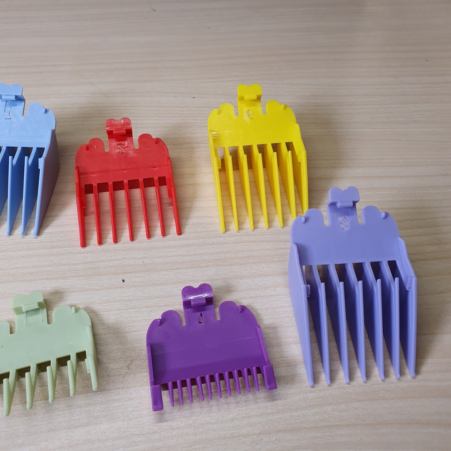 Colorful plastic limit combs designed to fit on professional hair clippers and trimmers.#6932