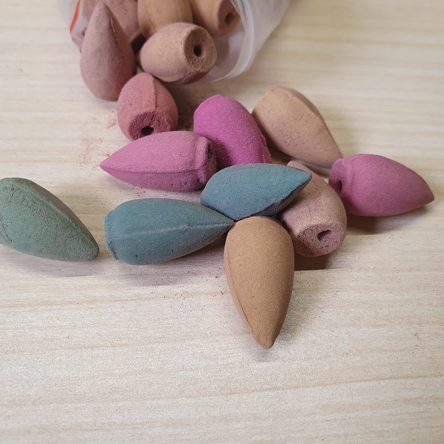 Colorful backflow incense cones designed to create a cascading smoke effect when placed on specialized burners #6732