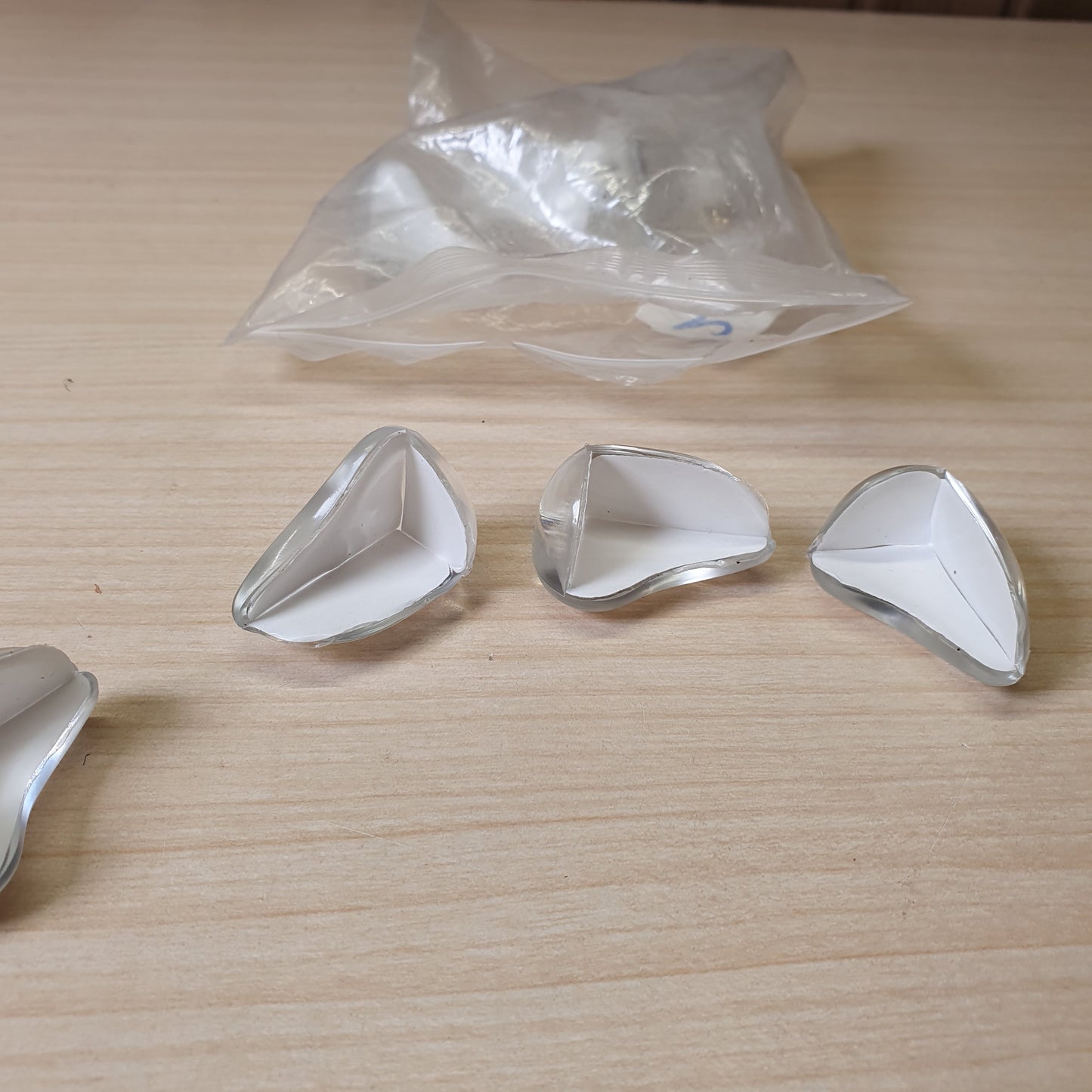Adhesive-backed corner guards are designed to baby-proof furniture by cushioning sharp edges.#6896
