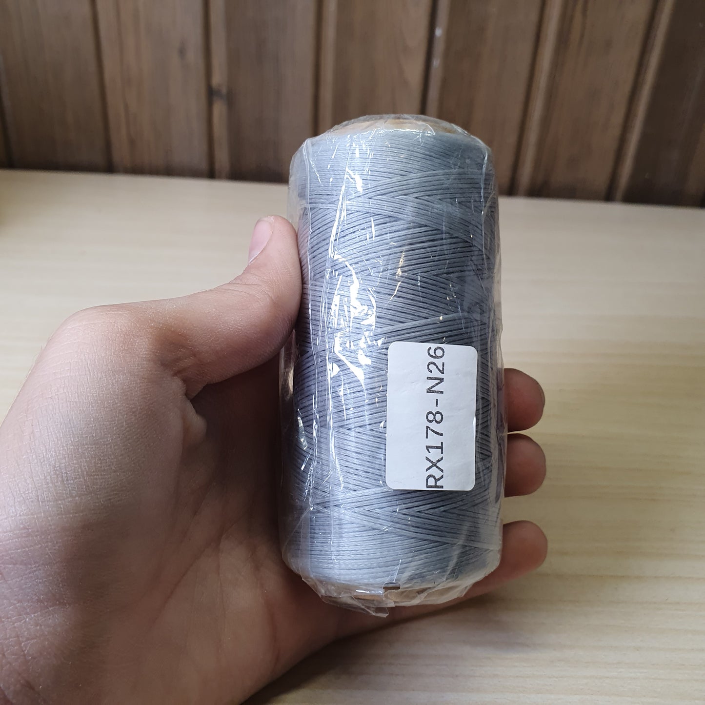 Spool of heavy-duty polyester or bonded nylon sewing thread, often used for leather crafting, upholstery, or canvas  #6583