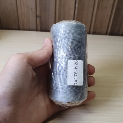 Spool of heavy-duty polyester or bonded nylon sewing thread, often used for leather crafting, upholstery, or canvas  #6583