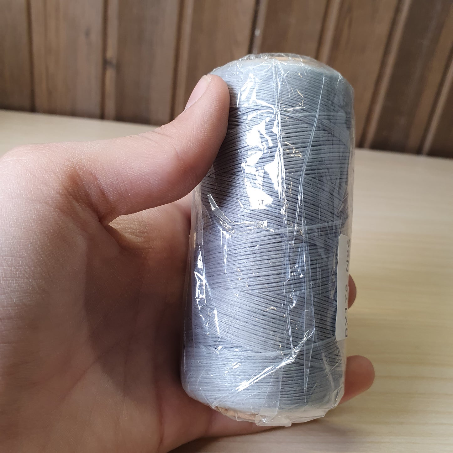 Spool of heavy-duty polyester or bonded nylon sewing thread, often used for leather crafting, upholstery, or canvas  #6583