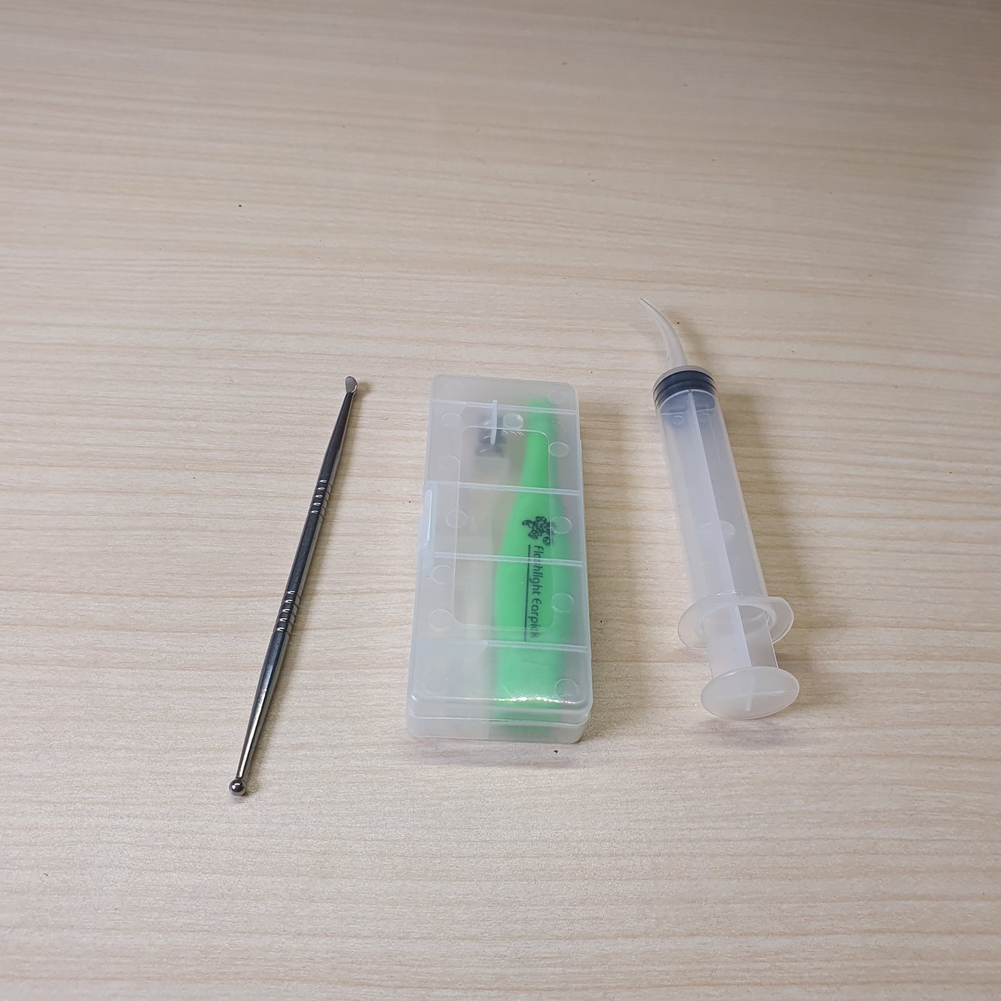 Green Flashlight Earpick, a tool used for ear cleaning that features a built-in LED light to help visualize the ear canal. #6561