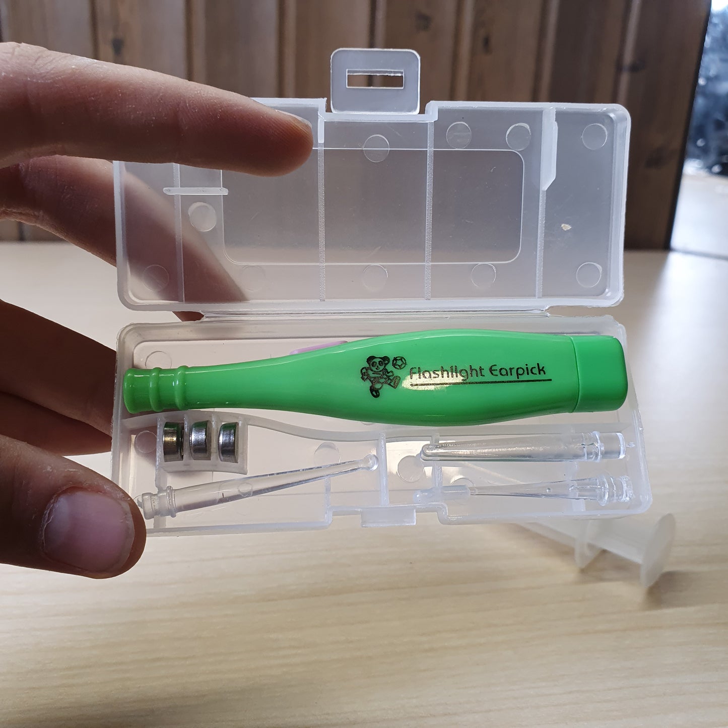 Green Flashlight Earpick, a tool used for ear cleaning that features a built-in LED light to help visualize the ear canal. #6561