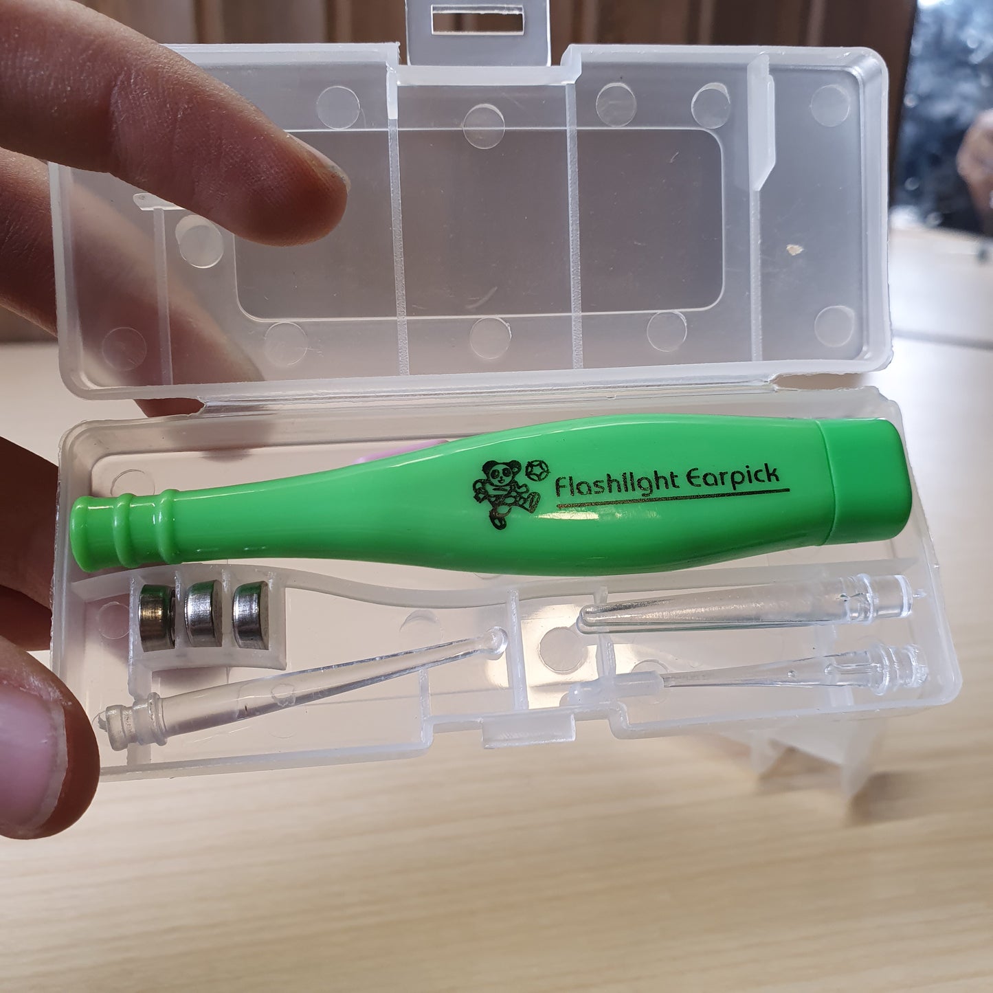 Green Flashlight Earpick, a tool used for ear cleaning that features a built-in LED light to help visualize the ear canal. #6561