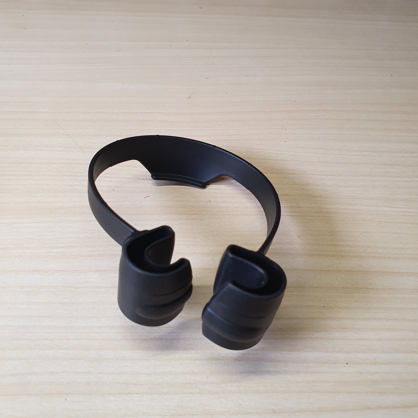 Black "OK Stand" is a flexible, TPU plastic phone holder designed with a thumbs-up shape for hands-free viewing in portrait or landscape modes. #6879