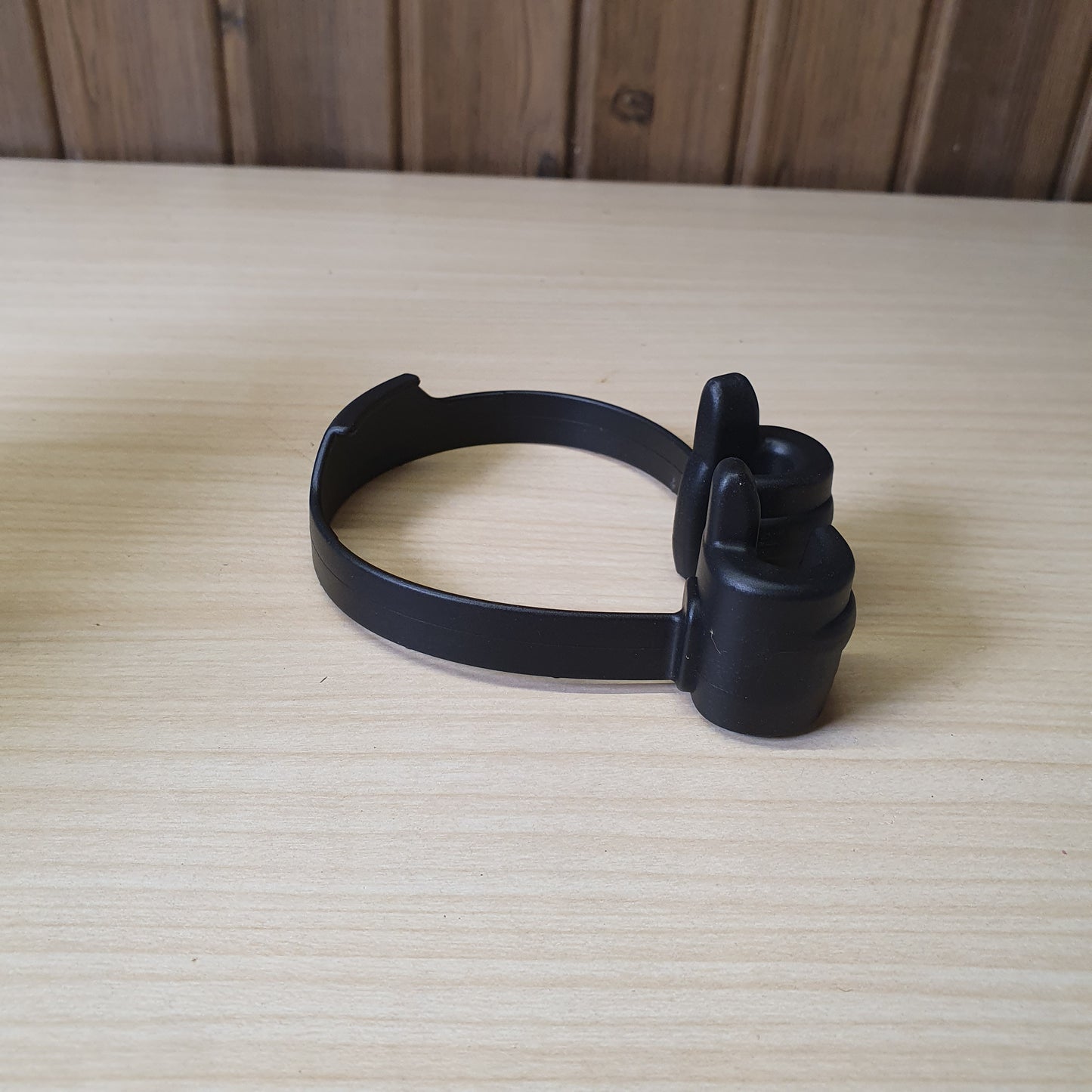 Black "OK Stand" is a flexible, TPU plastic phone holder designed with a thumbs-up shape for hands-free viewing in portrait or landscape modes. #6879