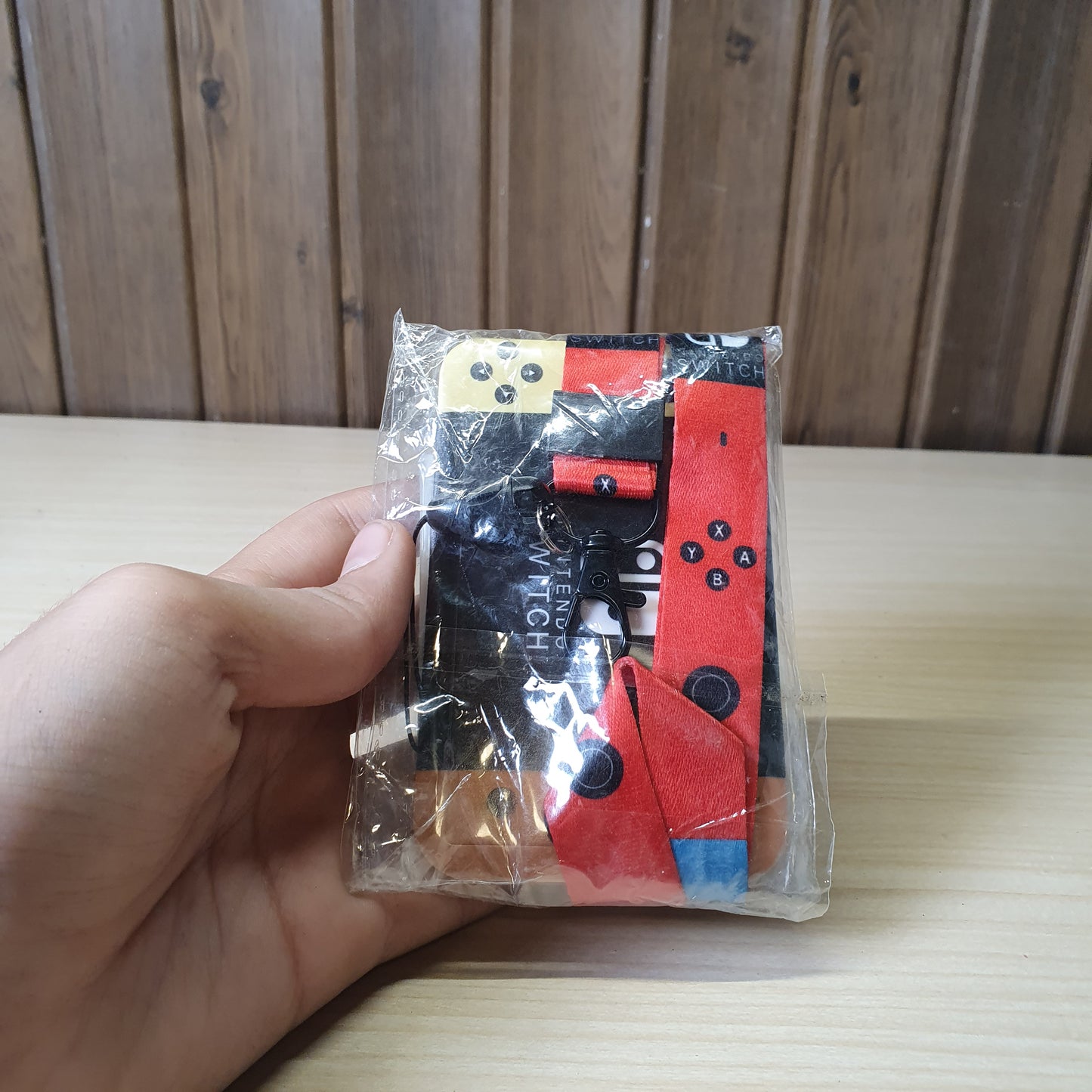 Nintendo Switch-themed card holder and lanyard set featuring the classic neon red and blue joy-con colors. #6852