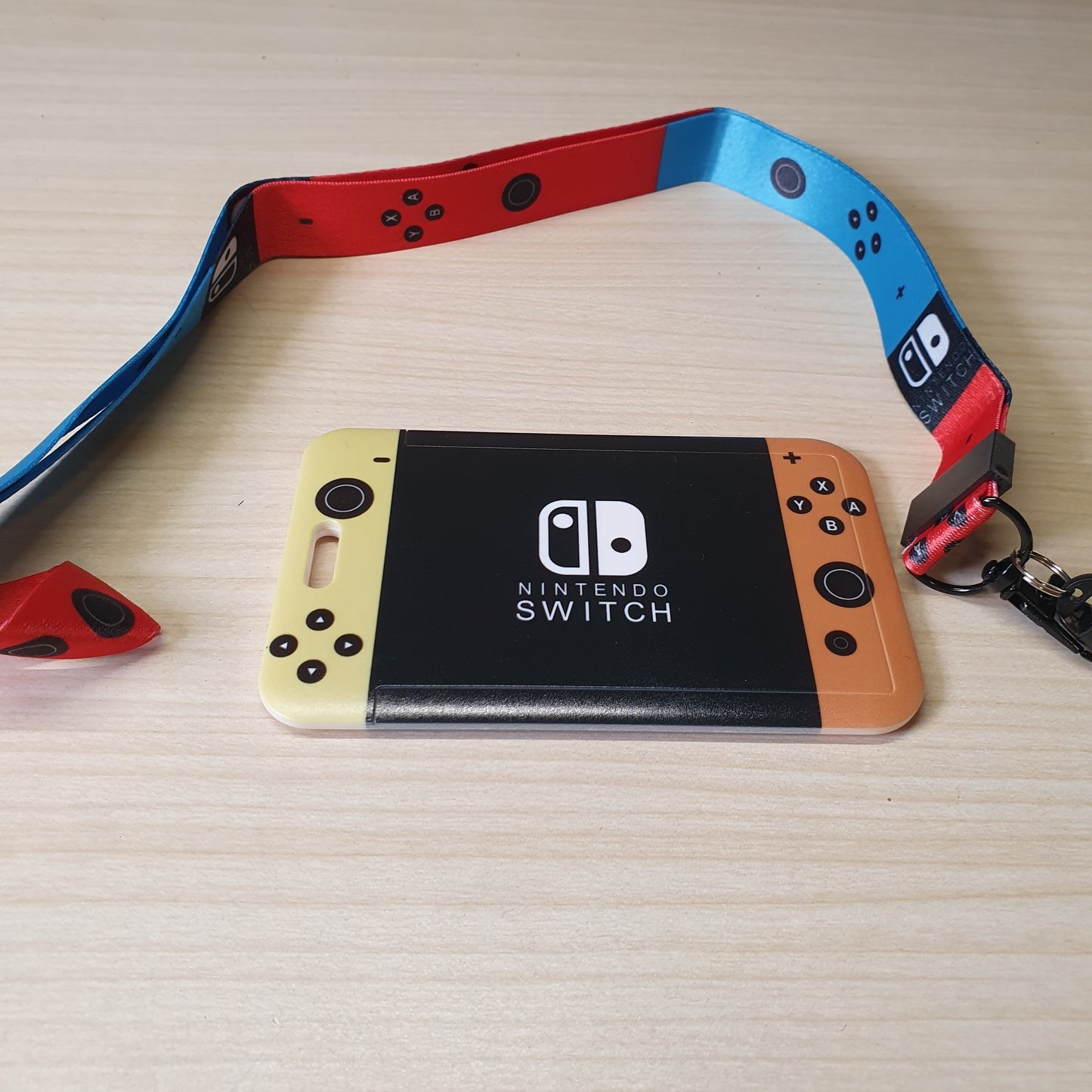 Nintendo Switch-themed card holder and lanyard set featuring the classic neon red and blue joy-con colors. #6852