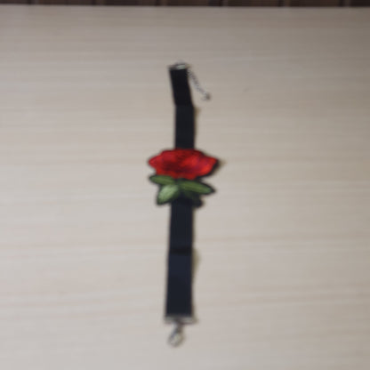 Black ribbon choker necklace features a prominent embroidered red rose patch and an adjustable silver-tone #6873