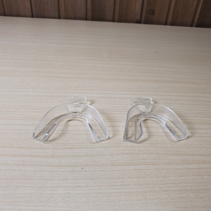 Clear plastic trays are designed for teeth whitening and bruxism protection, allowing you to create a custom mold by softening them in hot water. #6872