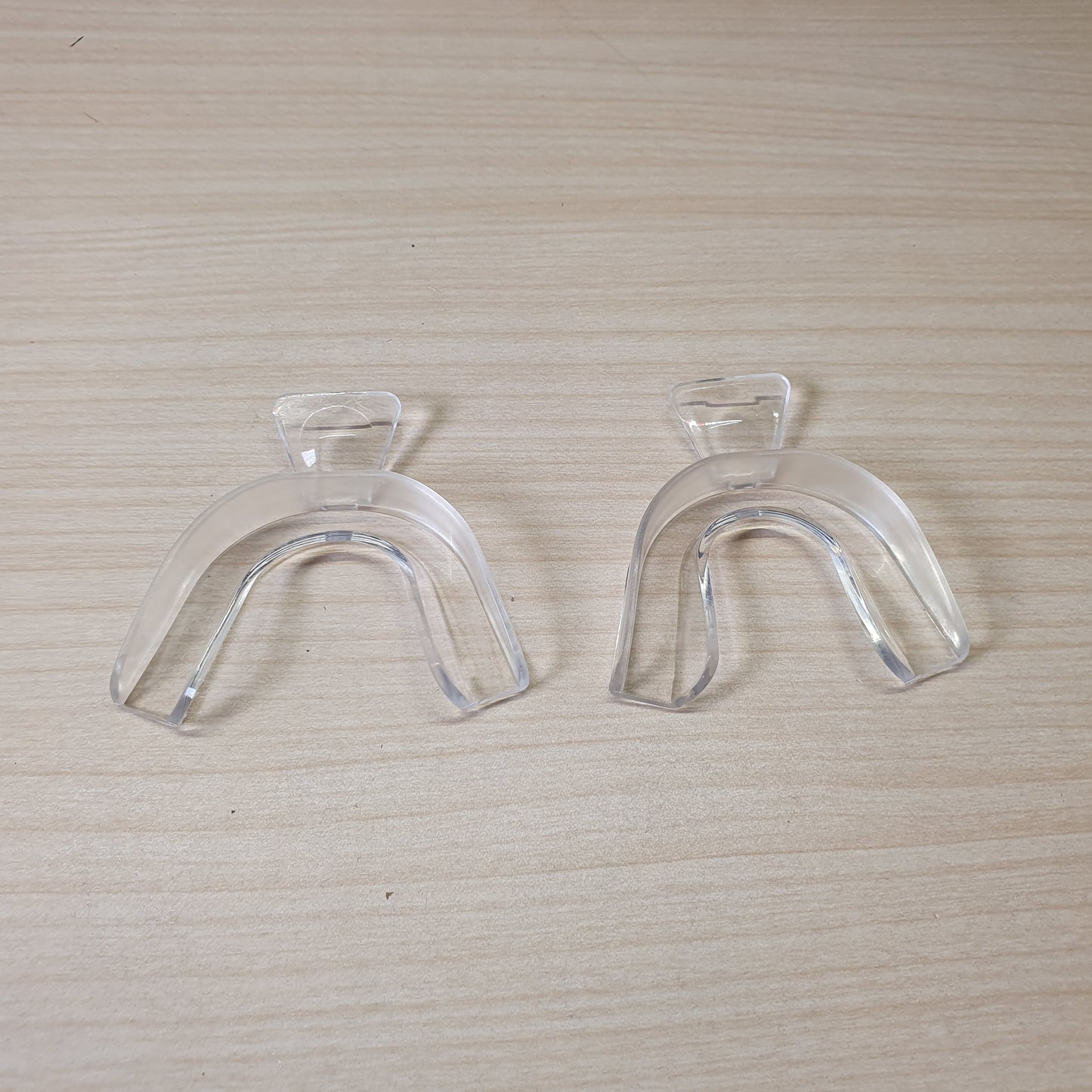 Clear plastic trays are designed for teeth whitening and bruxism protection, allowing you to create a custom mold by softening them in hot water. #6872
