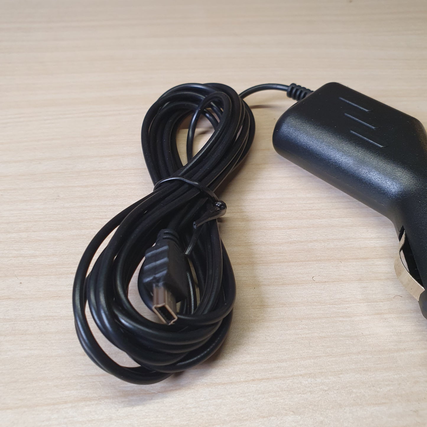Black car charger adapter features a straight-plug cigarette lighter connector and a built-in, coiled cable. #6816