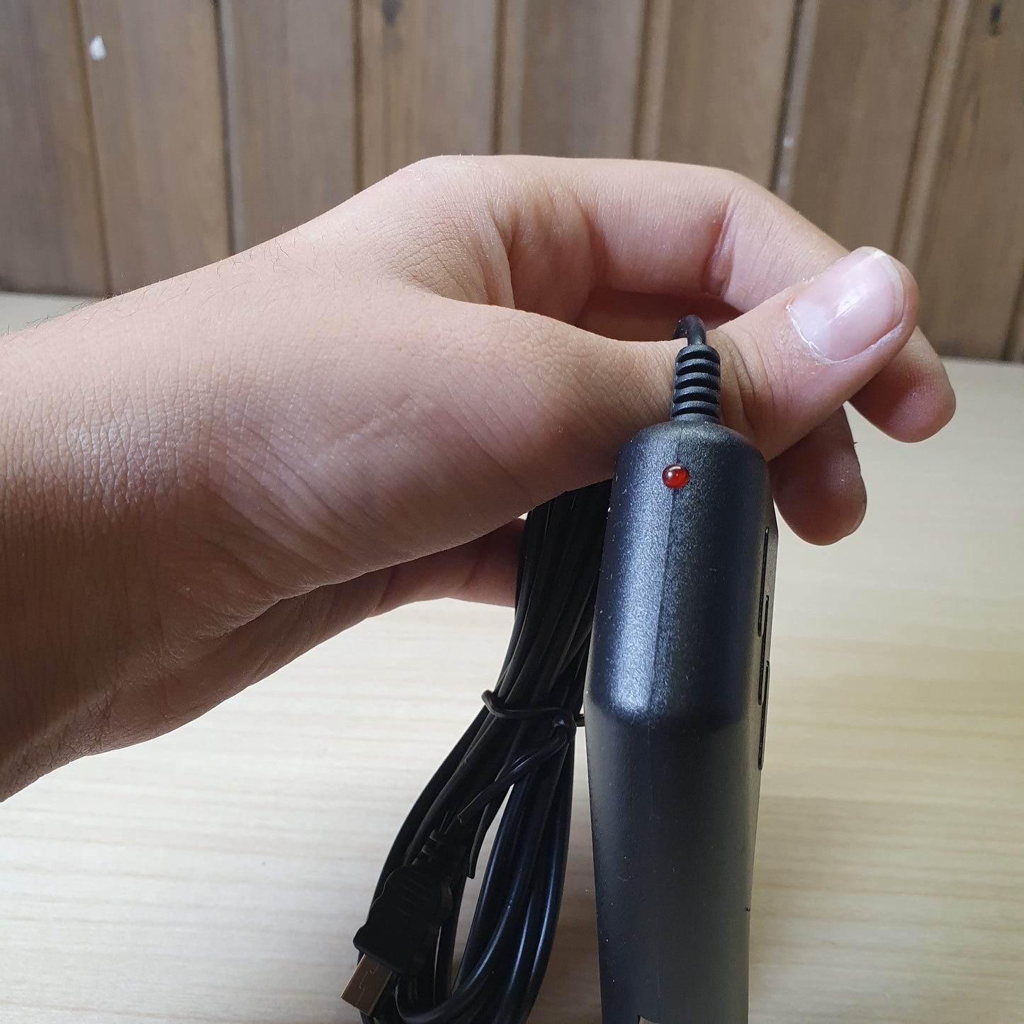 Black car charger adapter features a straight-plug cigarette lighter connector and a built-in, coiled cable. #6816