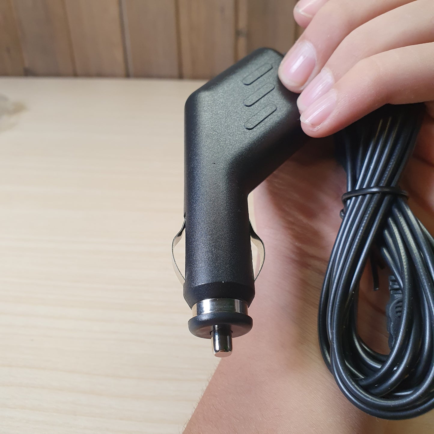 Black car charger adapter features a straight-plug cigarette lighter connector and a built-in, coiled cable. #6816